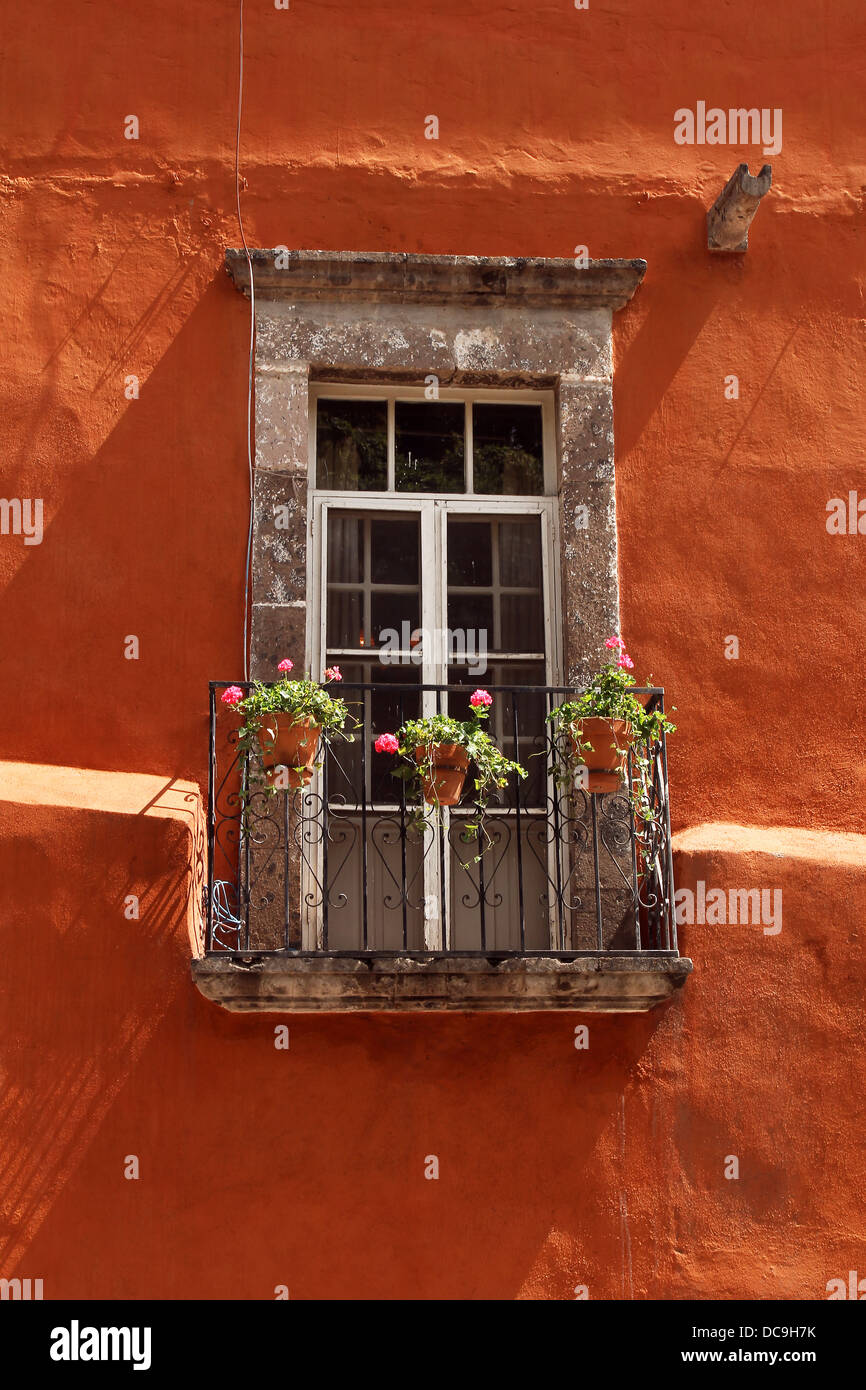 mexican window with balcony in orange wall Stock Photo Alamy