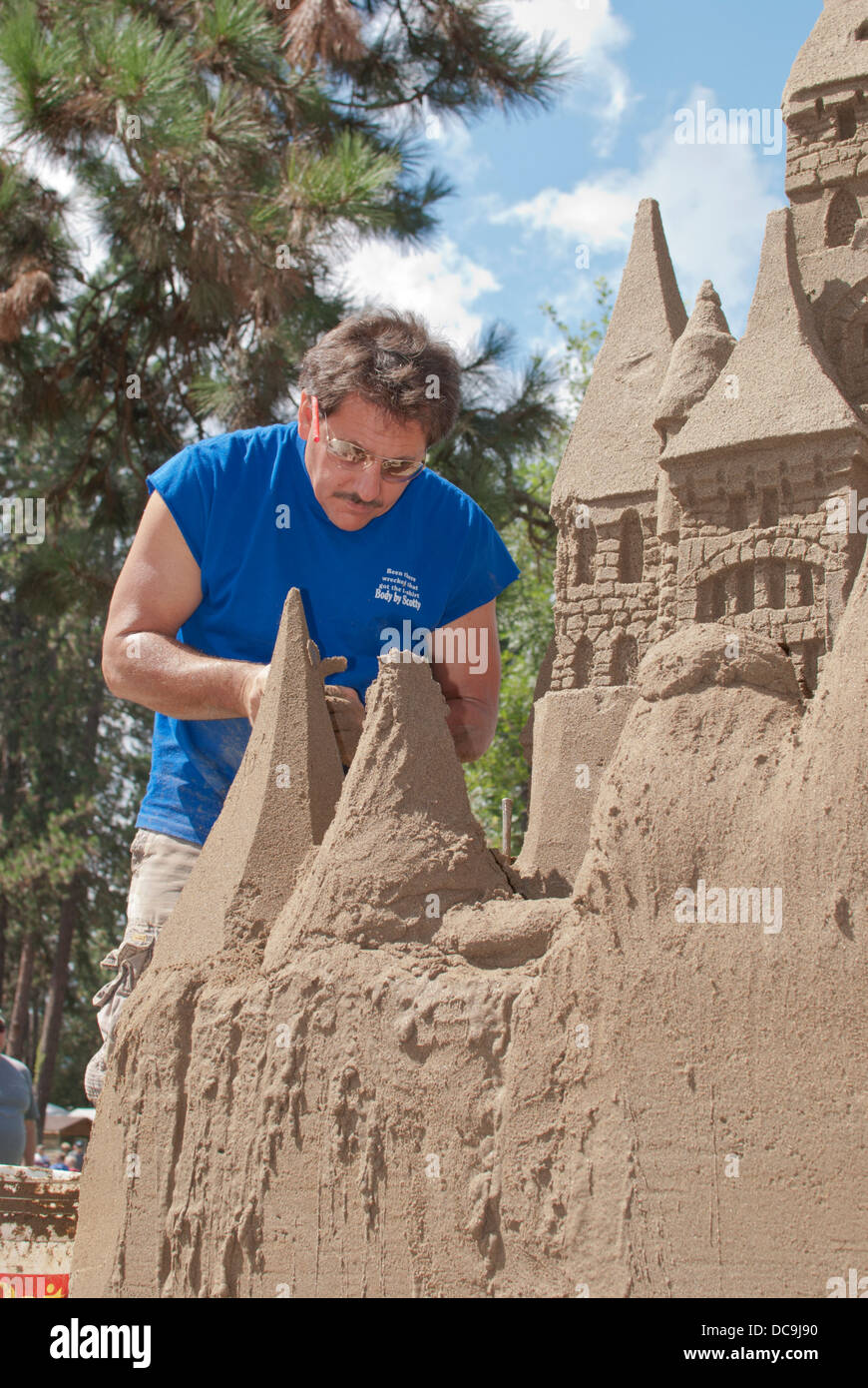 Artist sculpts a sandcastle at "Art on the Green" in Coeur d
