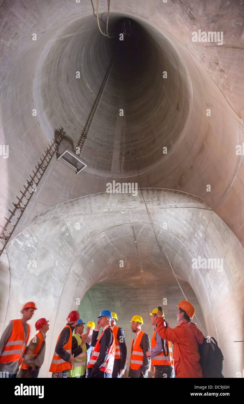 Jena, Germany. 13th Aug, 2013. Visitors look at the 130 high ventilation shaft in the Jagdbergtunnel near Jena, Germany, 13 August 2013. The six-lane Autobahn tunnel will open in the middle of 2014 and is part of the A4, that has been widened at a cost of 330 million euros. Photo: MICHAEL REICHEL/dpa/Alamy Live News Stock Photo