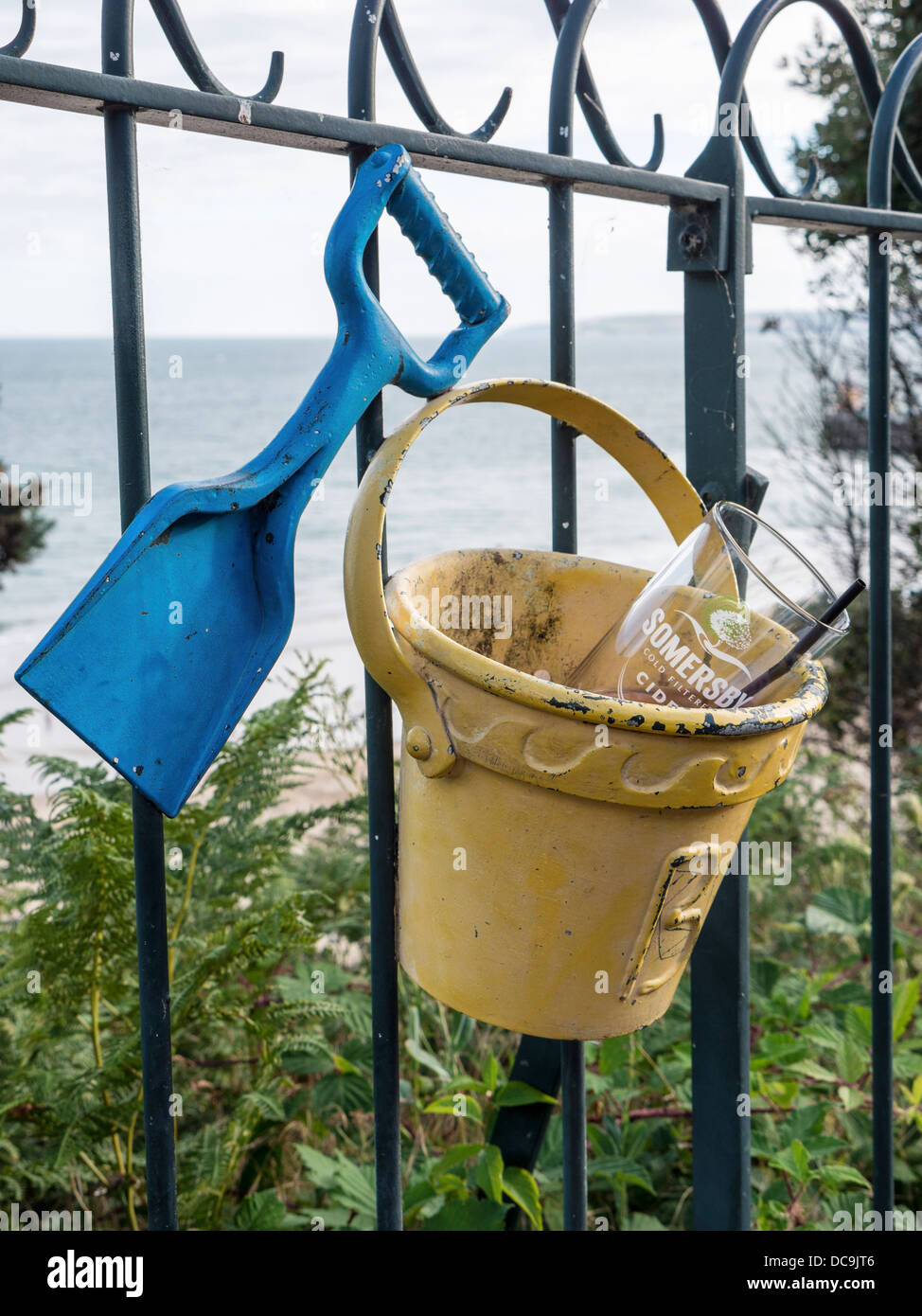 Metal bucket and spade is used as trash container on the decorative