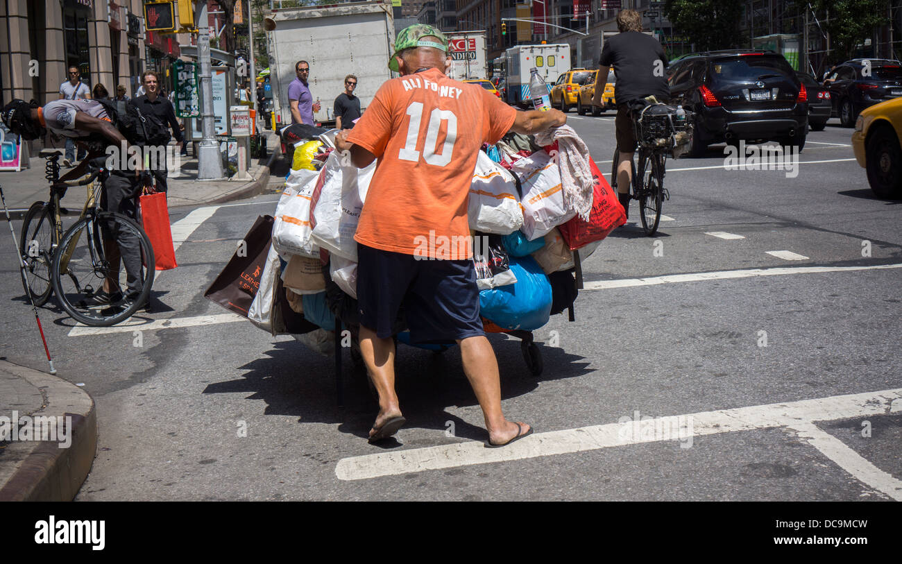 A deposit bottle collector with his possessions in the Chelsea