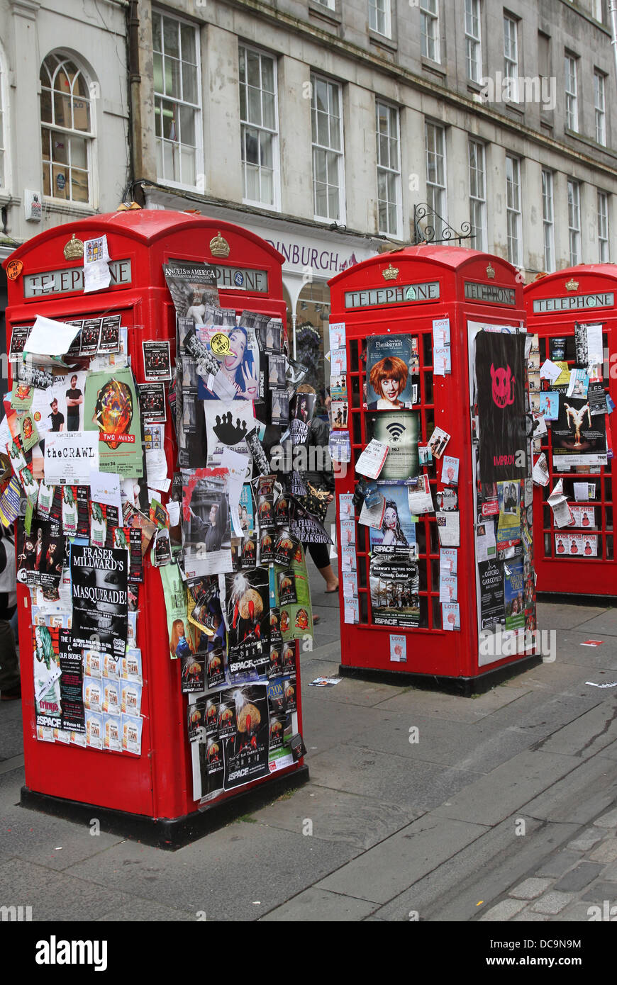 Red phone boxes covered with flyers Royal Mile Edinburgh Scotland August 2013 Stock Photo