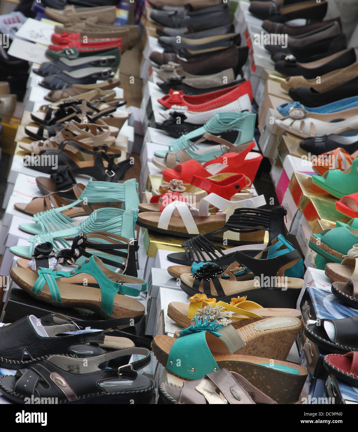 Sandals and shoes for trendy young women sold at local market Stock Photo -  Alamy