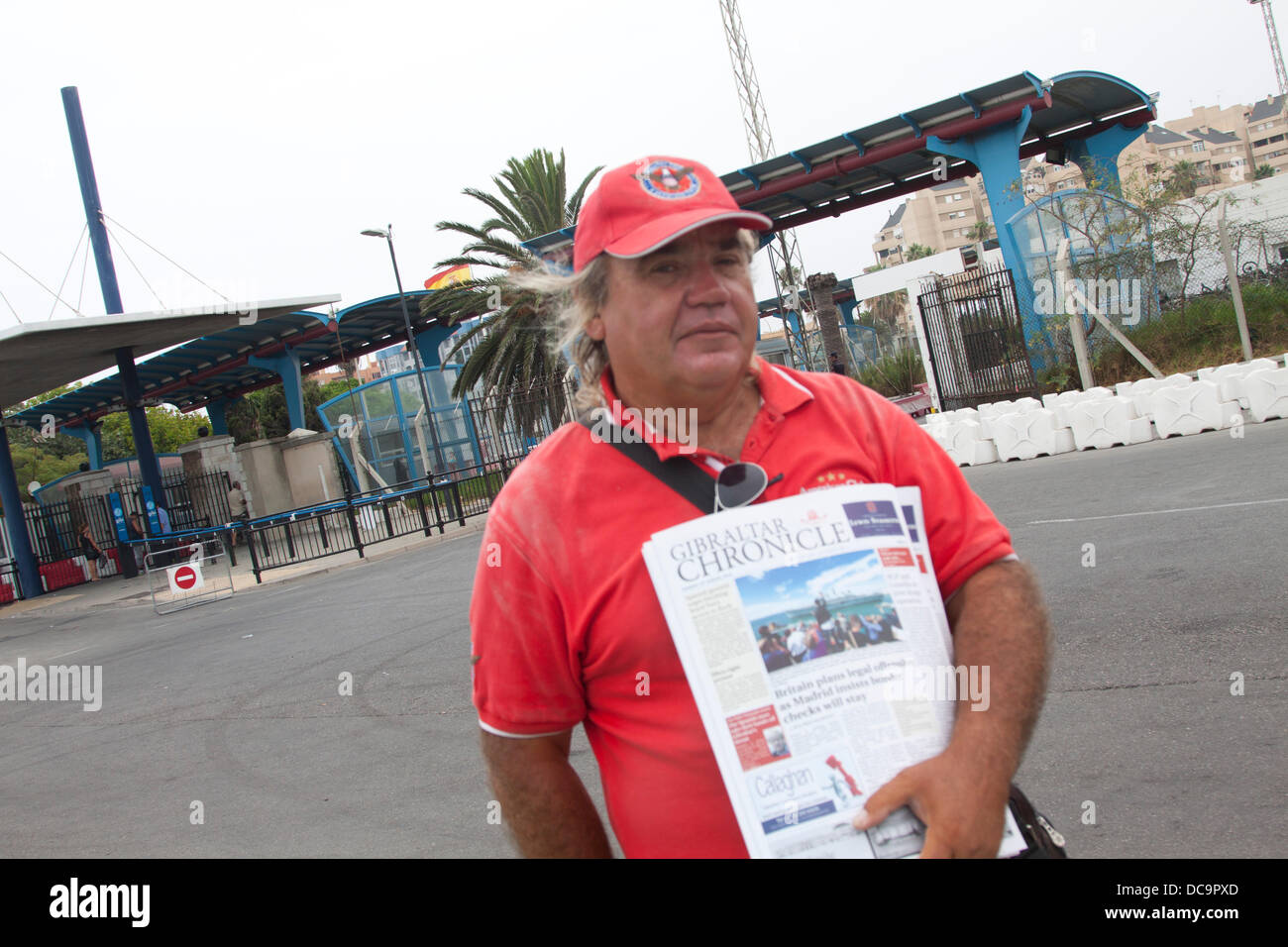 Gibraltar. 13th August 2013. A newspaper vendor selling the Gibraltar Chronicle as tourists are caught up in the dispute between the British government and Spain and recently the Spanish authorities have started to delay traffic leaving Spain and entering Gibraltar by carrying out lengthy vehicles searches and document checks. Credit:  amer ghazzal/Alamy Live News Stock Photo