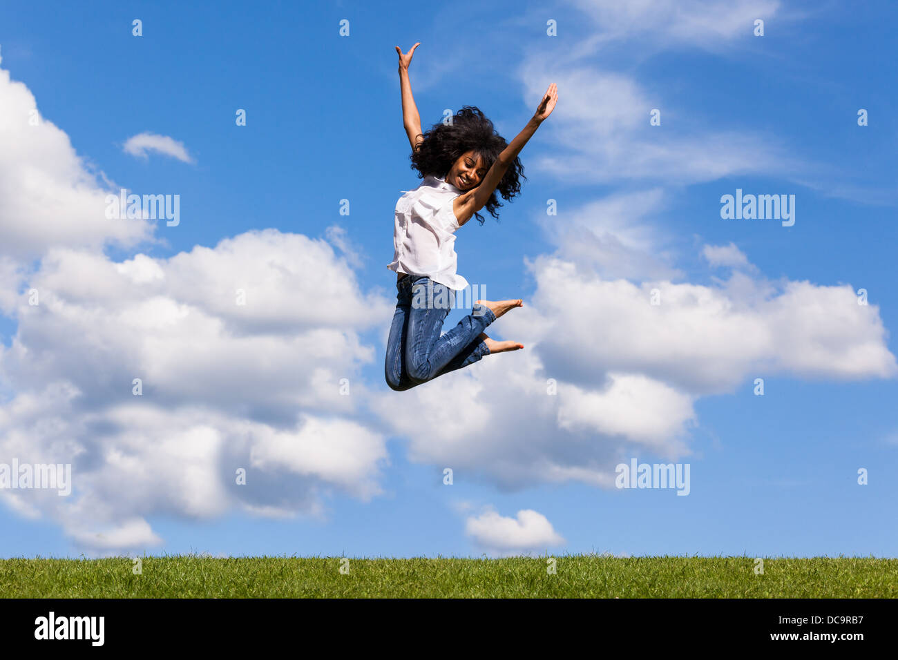 Happy girl jumping blue sky hi-res stock photography and images - Alamy