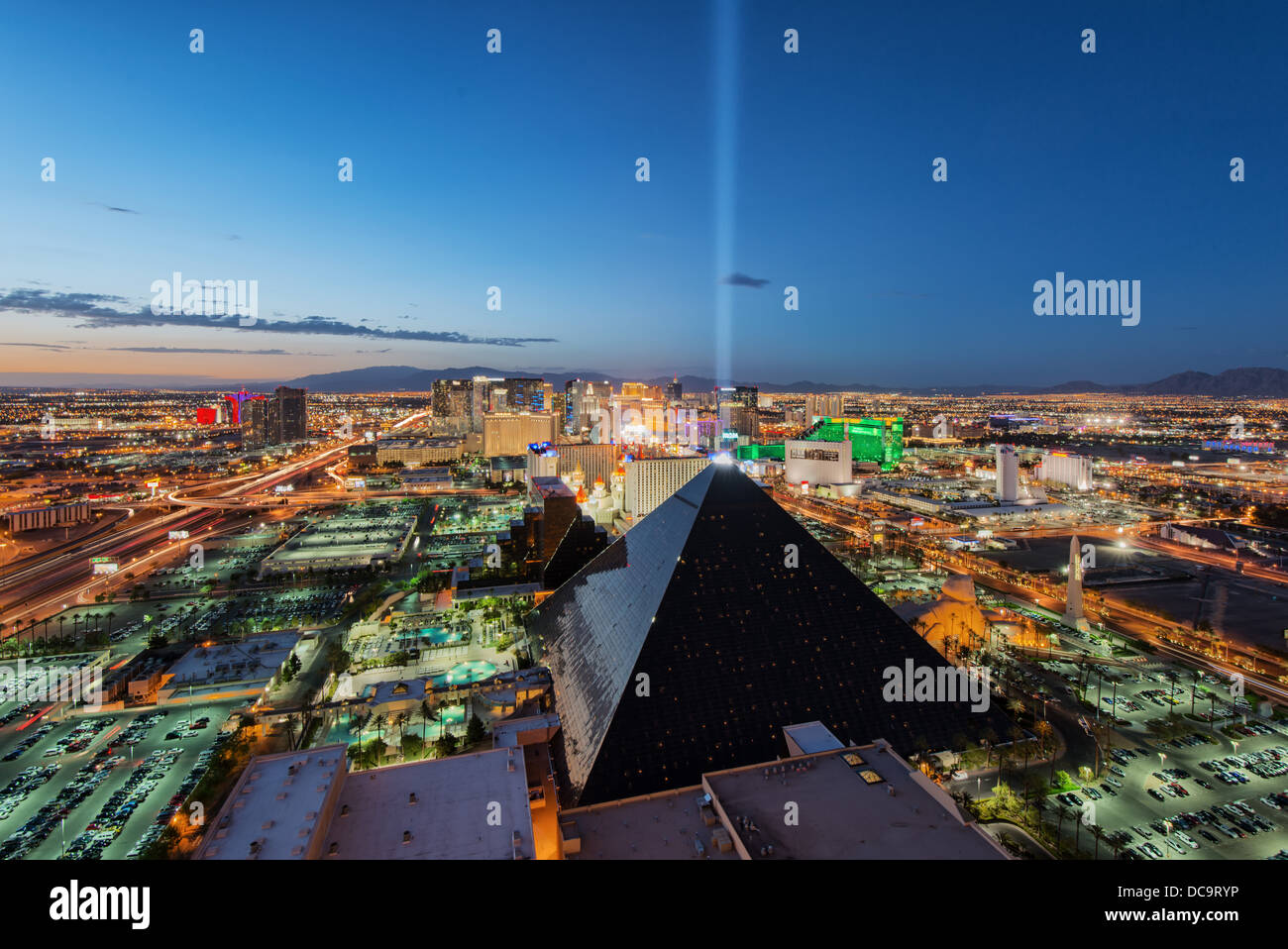 Louxor Casino and Hotel and Las Vegas skyline at the blue hour as seen from the Mix Lounge terrace at THEhotel, Las Vegas,Nevada Stock Photo