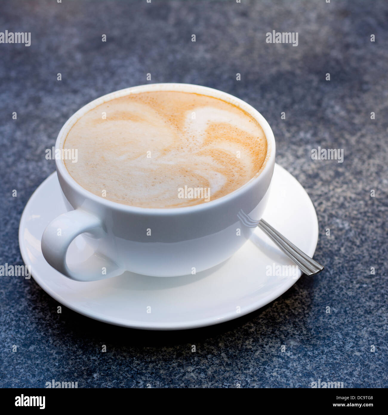 Coffee drink, soy latte, with saucer and spoon Stock Photo