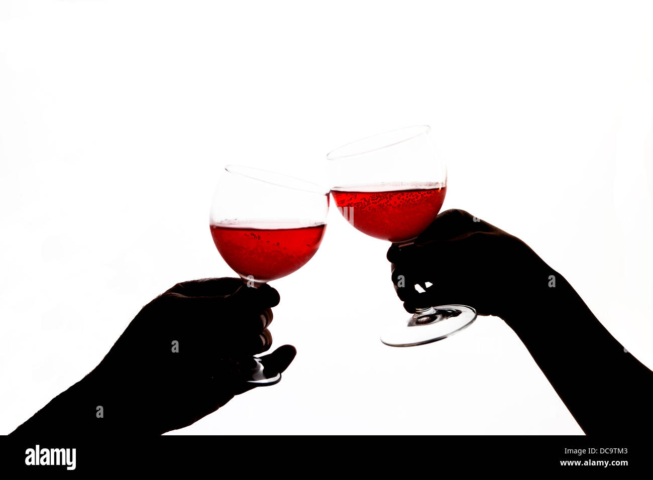 Holding wine glasses. Stock Photo