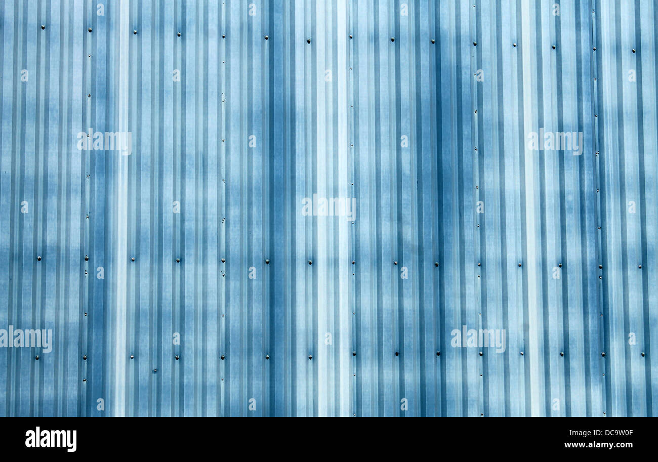 Abstract background of blue corrugated metal on warehouse building. Stock Photo