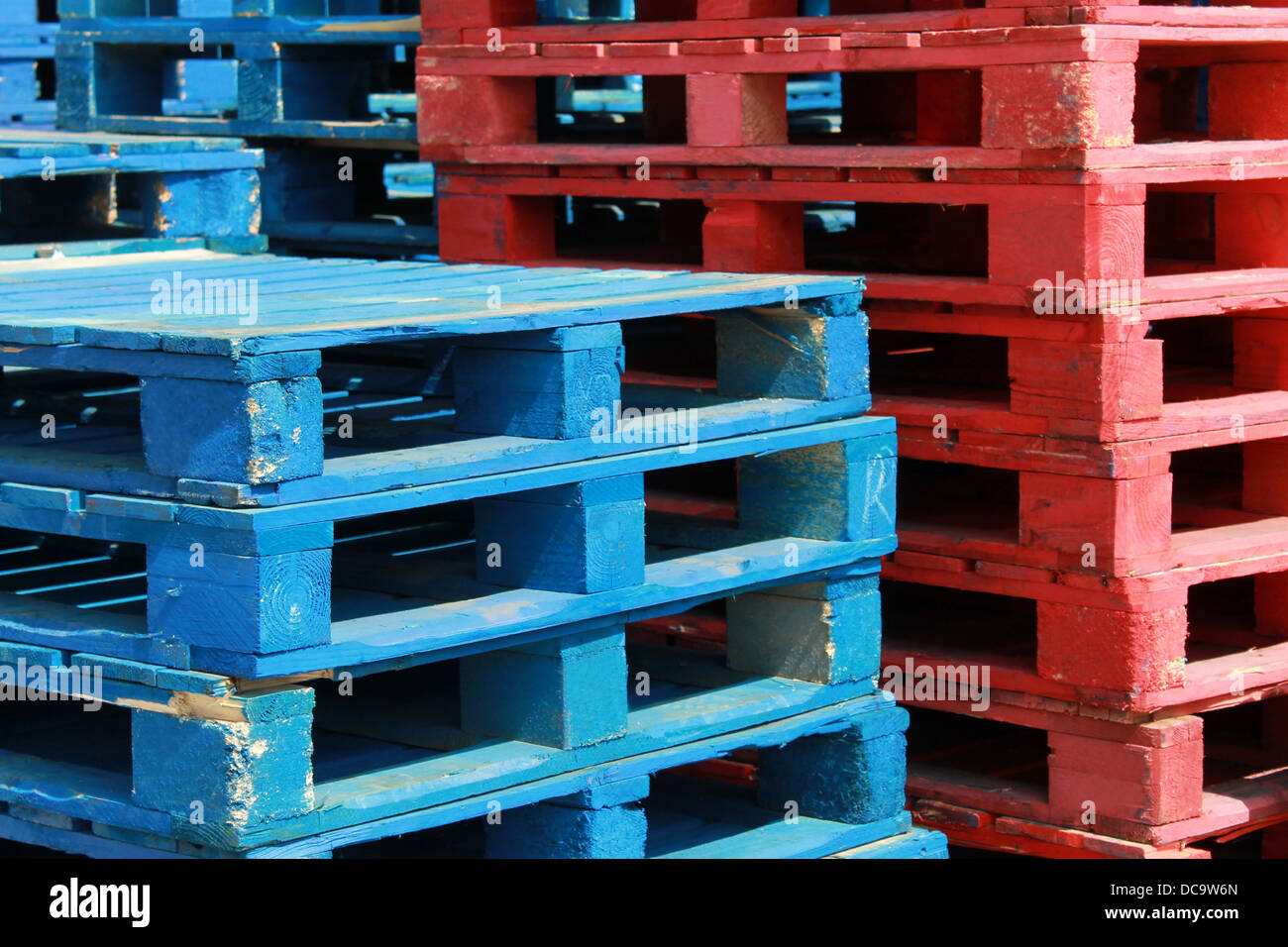 Colorful stacks of red and white crate pallets. Stock Photo