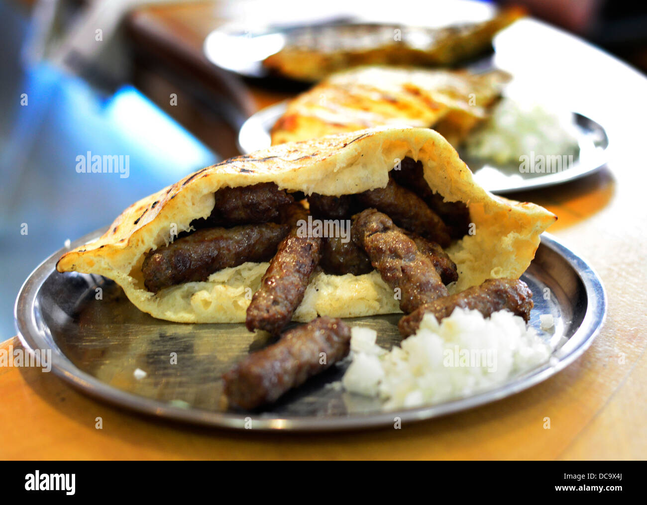 ćevapčići - A minced meat Kebab dish served in a Somun - Thin pita bread is a national dish in Serbia and Bosnia. Stock Photo