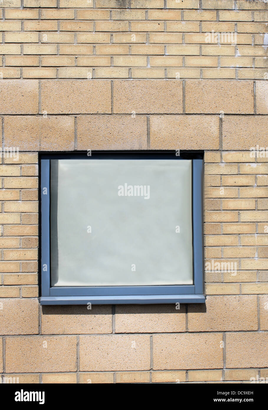 Window on exterior of modern brick office building. Stock Photo