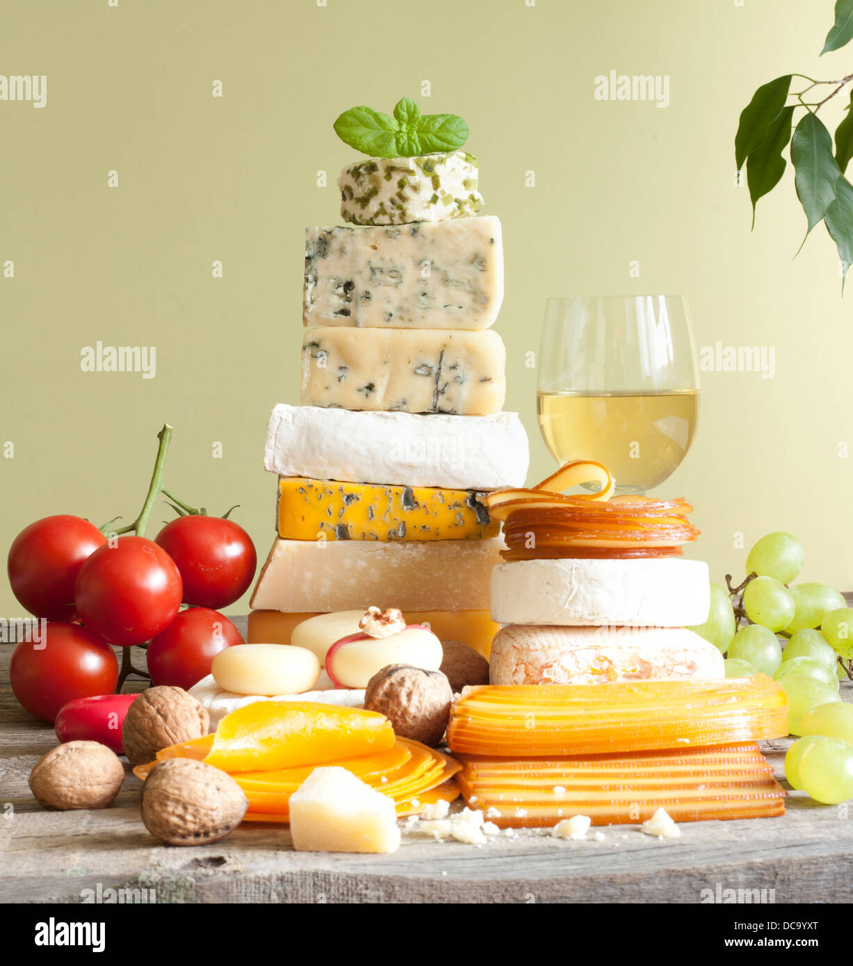 Pile of cheese many various types with wine grapes and walnuts Stock Photo