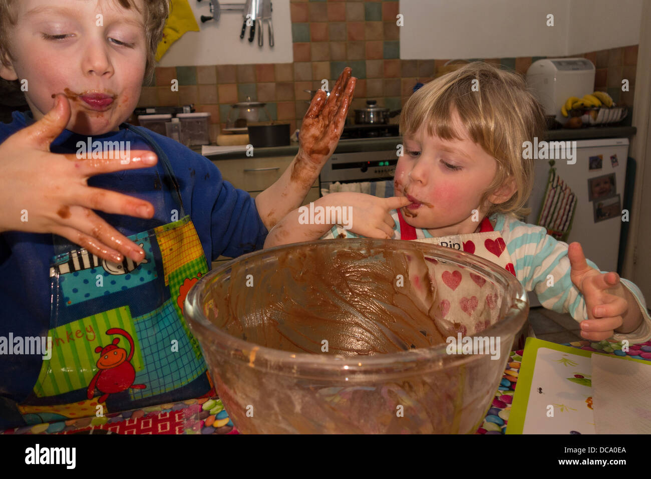 Boy licking fingers cake hires stock photography and images Alamy