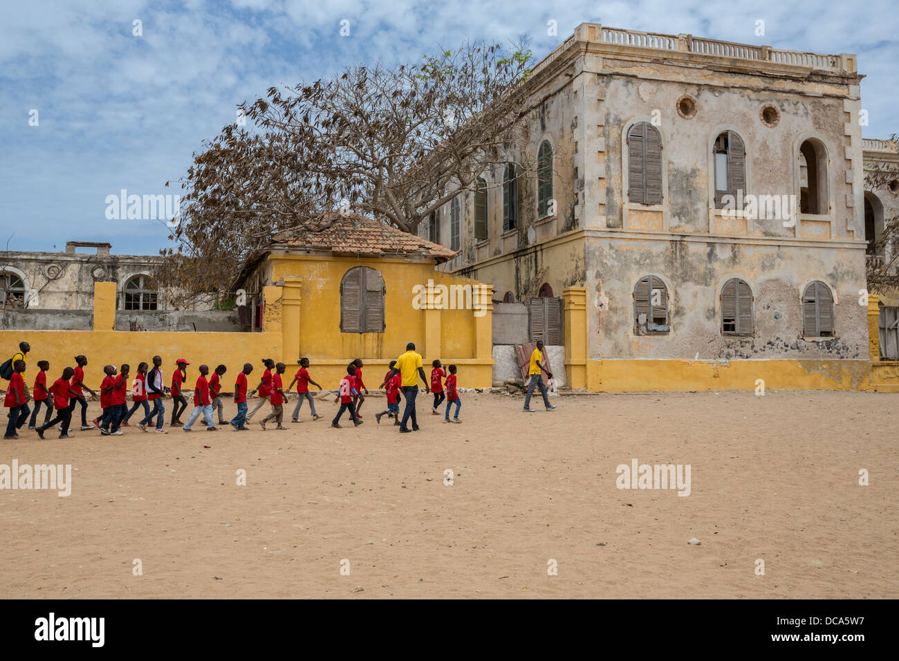 School Children Visiting Goree Island, Senegal. Walking by the Abandoned Residence of the French Colonial Governor. Stock Photo