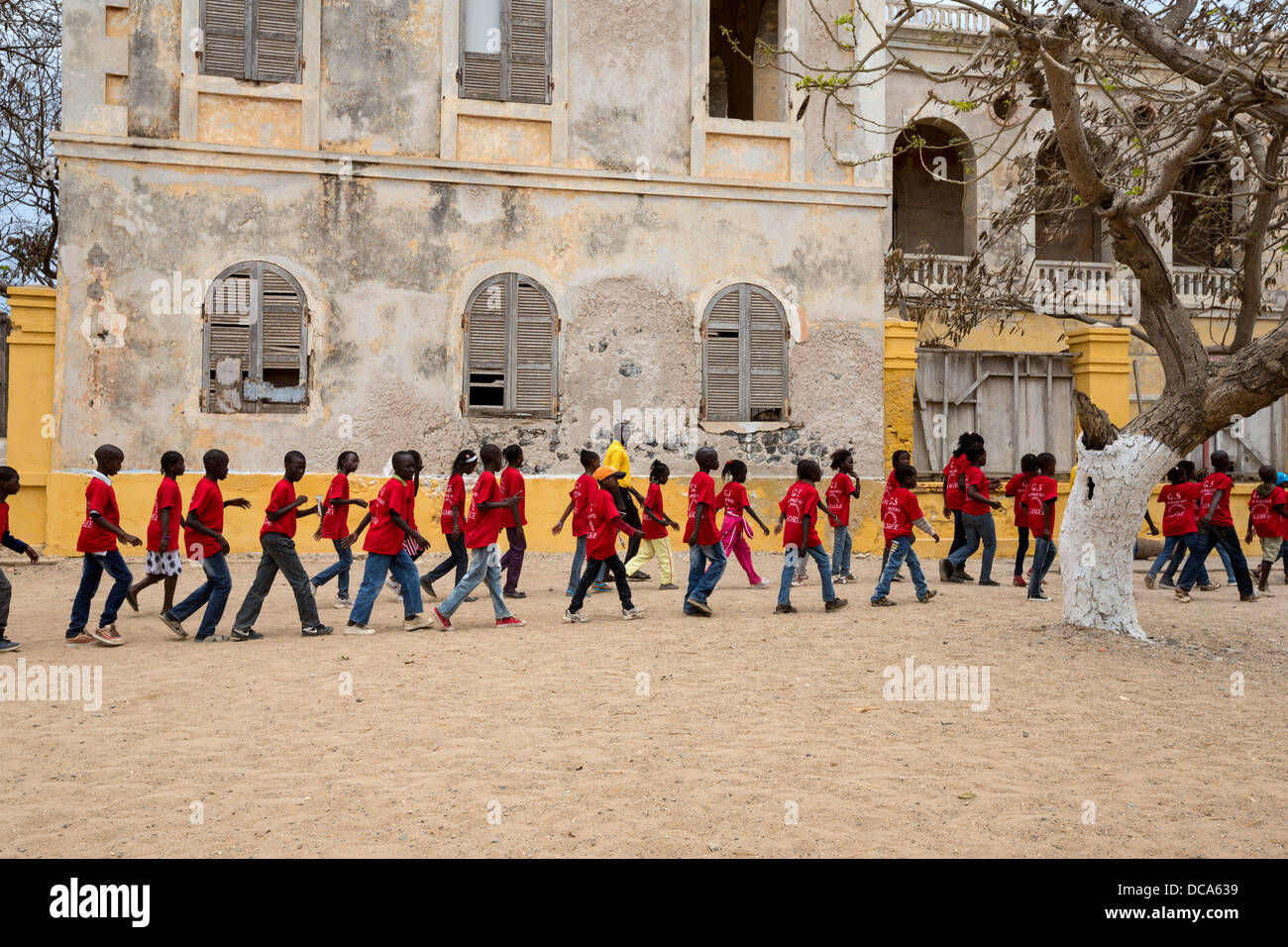 School Children Visiting Goree Island, Senegal. Walking by the Abandoned Residence of the French Colonial Governor. Stock Photo