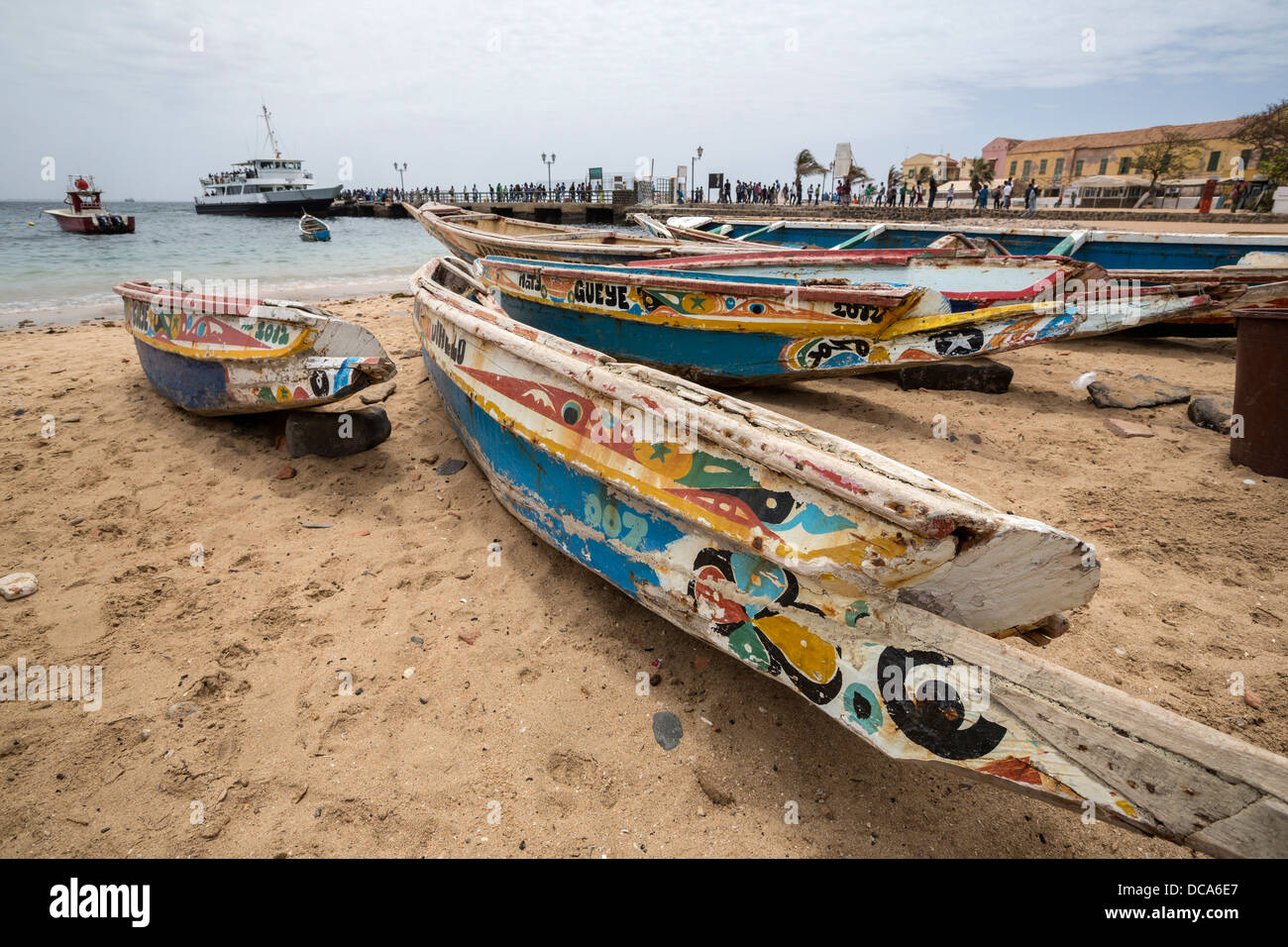 Fishing Boats on the Beach, Dakar-Goree ferry in the Background. Goree Island, Senegal. Stock Photo