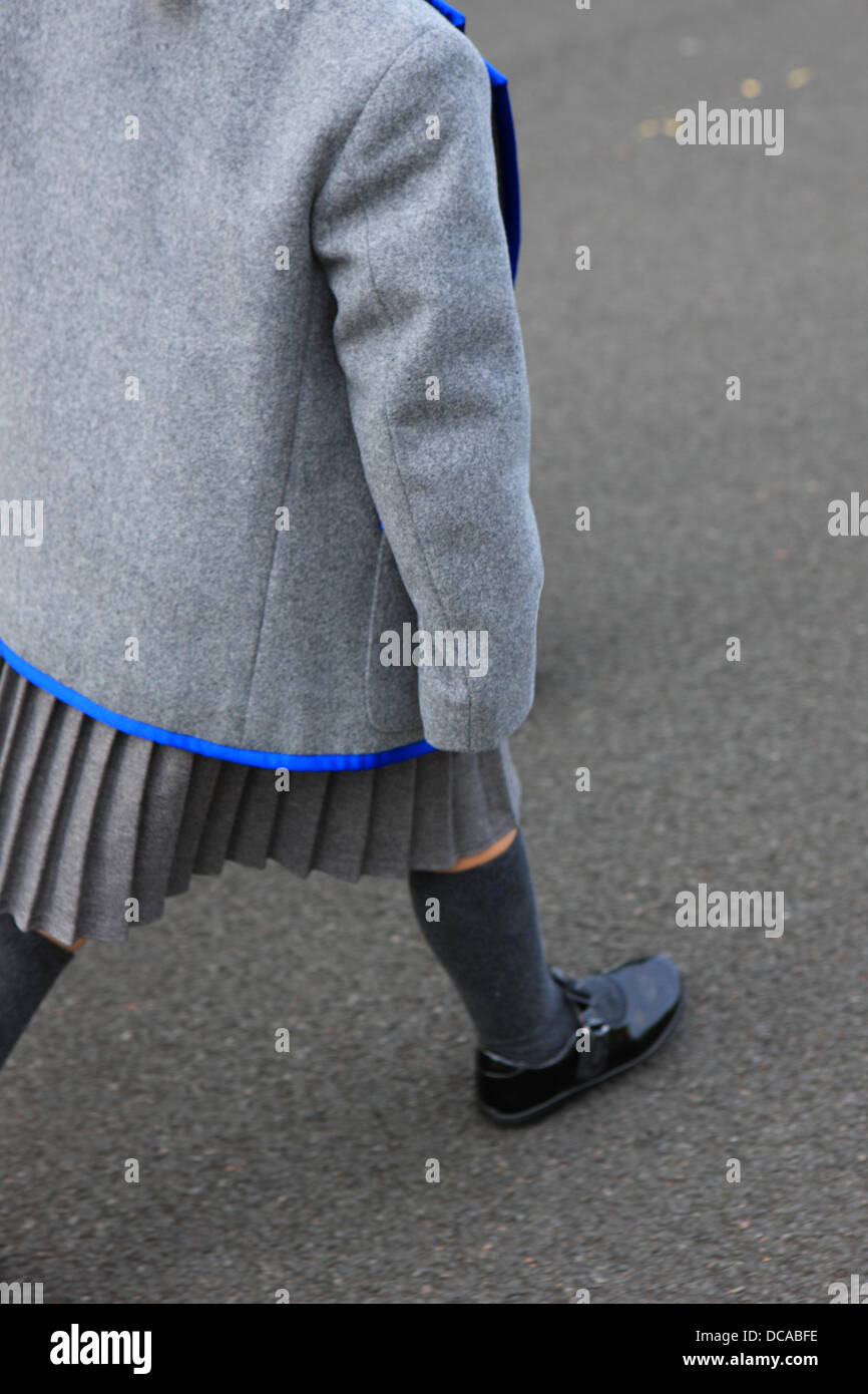 East Renfrewshire, Scotland, UK. 14th August 2013. Young 4 year old girl in her new school uniform taking her first steps into the school playground for the first day of primary school in East Renfrewshire Scotland as the Scottish schools return after the summer break. Credit:  PictureScotland/Alamy Live News Stock Photo