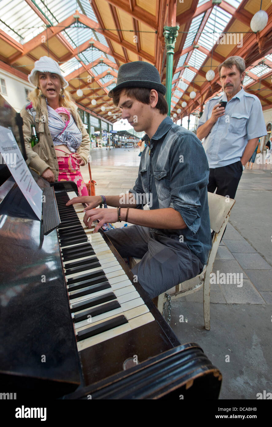 Prague, Czech Republic. 13th August 2013. People play public accessed piano at Prague's Masaryk railway station, Czech Republic as coffee owner Ondrej Kobza placed pianos on several places in Prague where people can play these music instruments freely. Kobza wants to make the public area more cosy. (CTK Photo/Vit Simanek/Alamy Live News) Stock Photo