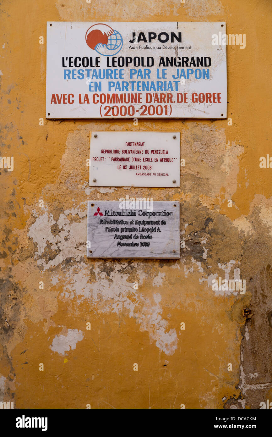 Sign Commemorating a Japanese Economic Assistance Program, Restoring a School, Goree Island, Senegal. Stock Photo