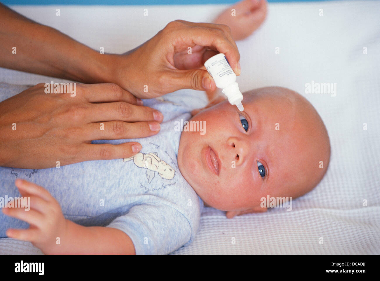 Mother S Hand Putting Eye Drops In A Baby S Eye Stock Photo Alamy