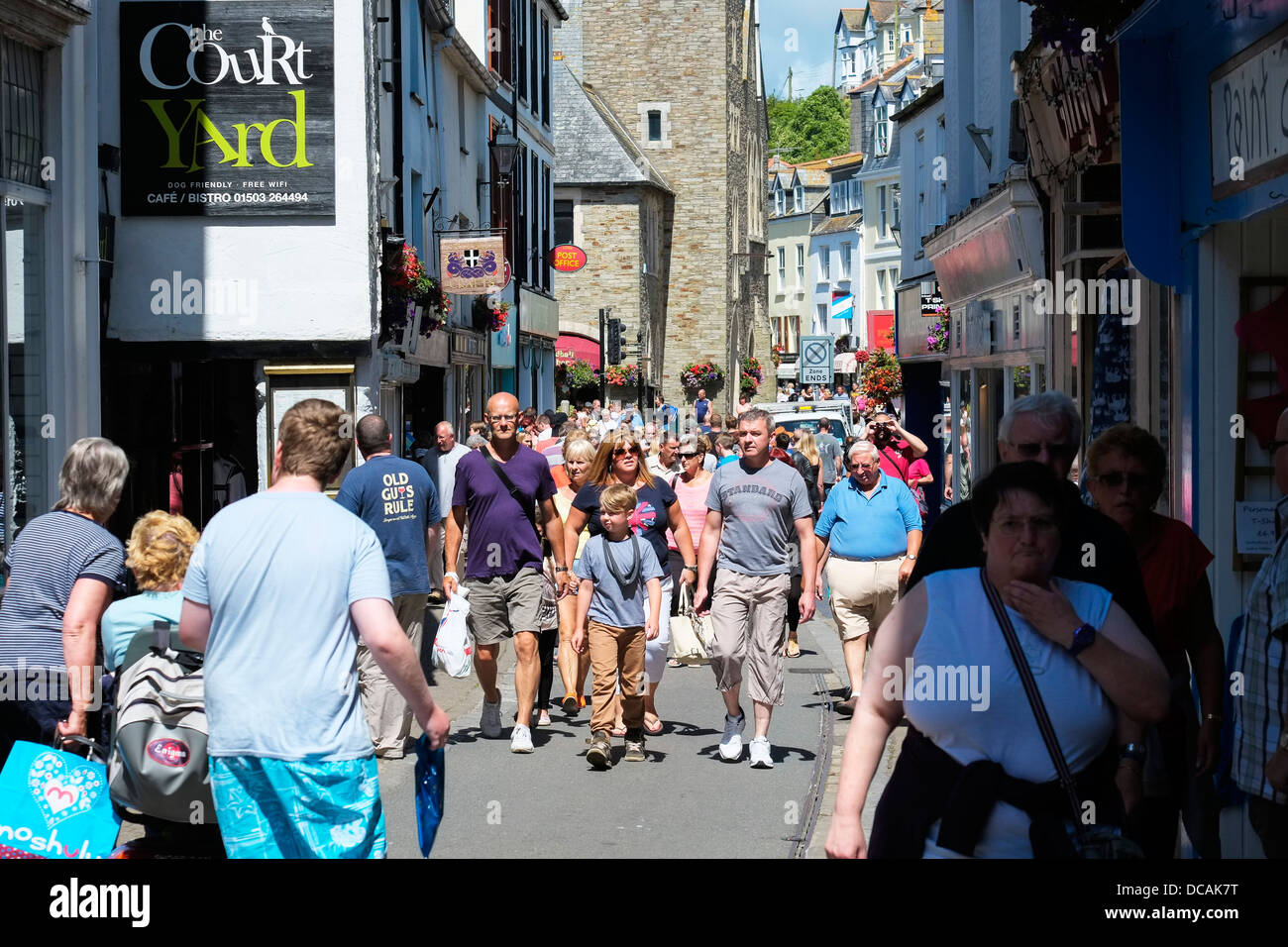 Holidaymakers walking through the Fore Street in Looe in Cornwall. Stock Photo