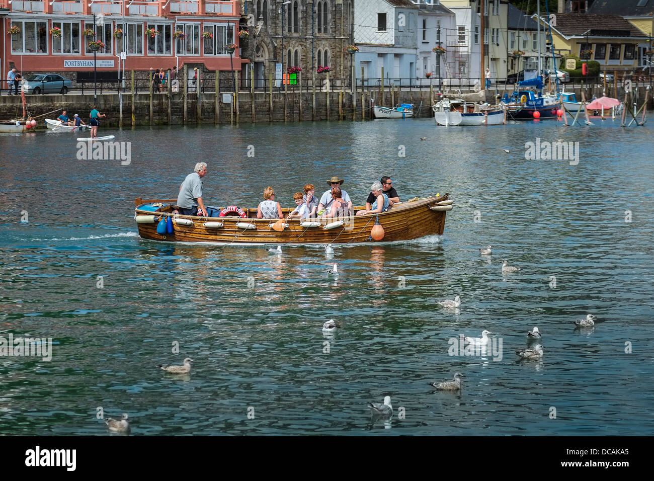 The Looe Ferry carrying passengers across the river. Stock Photo