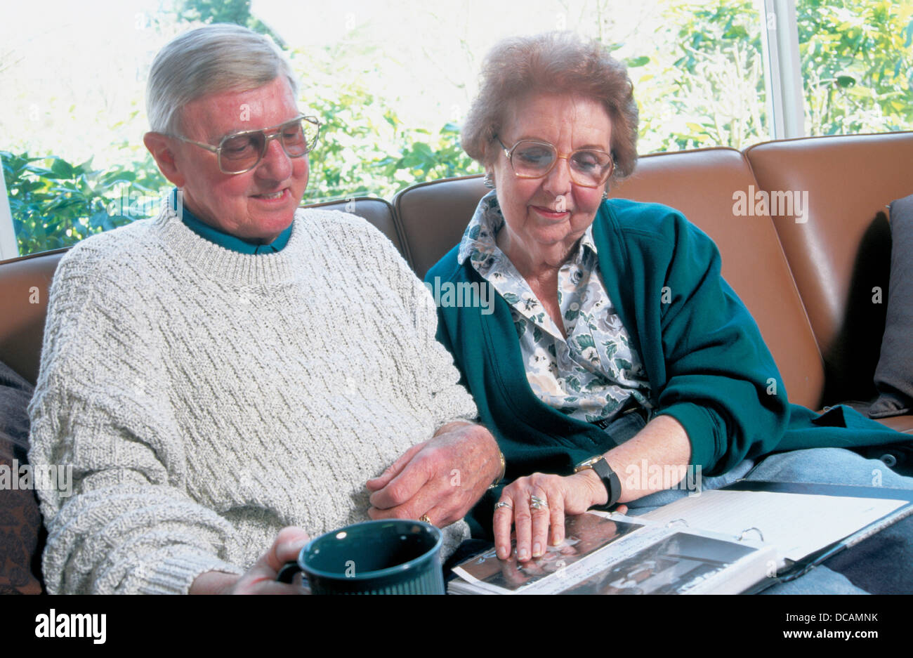 Senior couple looking at phot album Stock Photo