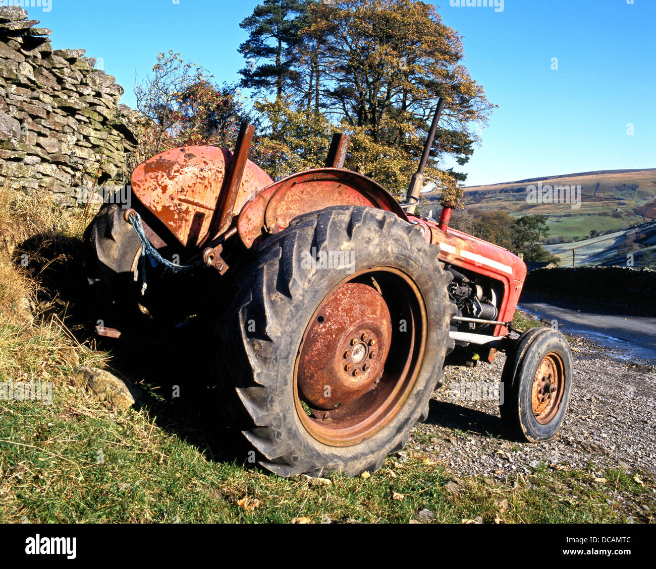 Tractor parked by a dry stone wall, Thwaite, Yorkshire Dales, North Yorkshire, England, UK, Great Britain, Western Europe. Stock Photo