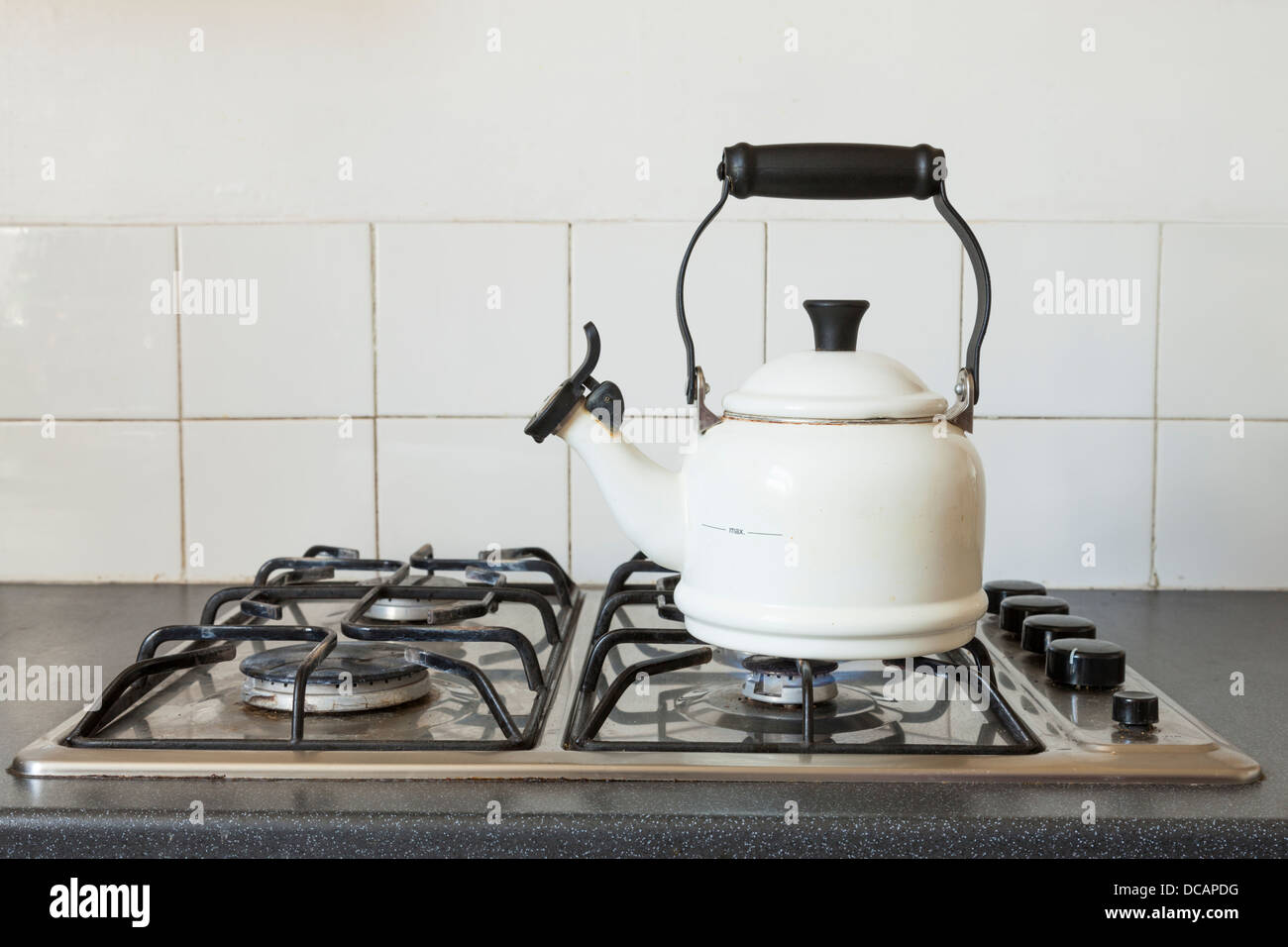 Kettle on a hob of a gas cooker, England, UK Stock Photo