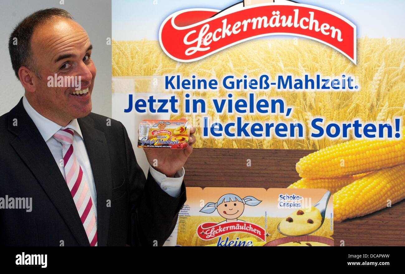 Weißenfels, Germany. 14th Aug, 2013. Inventor Curd Kießler holds the new product called 'small semolina meal' ('kleine Grieß-Mahlzeit') at milk factory frischli in the location Weißenfels, Germany, 14 August 2013. The company presented together with th headquarters in Rehberg four new products with semolina© PETER ENDI /dpa picture alliance/Alamy Live News Stock Photo