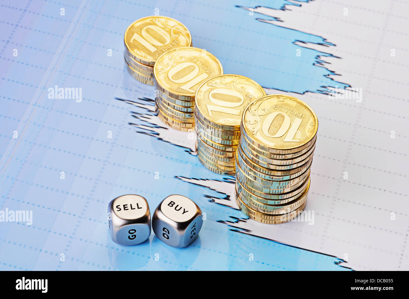 Dices cubes with the words SELL BUY, uptrend stacks of golden coins and financial chart as background. Selective focus. Stock Photo