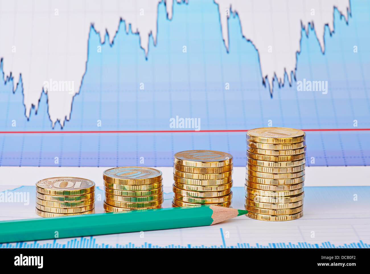 Uptrend golden coin stacks, green pencil and financial chart as background. Selective focus Stock Photo