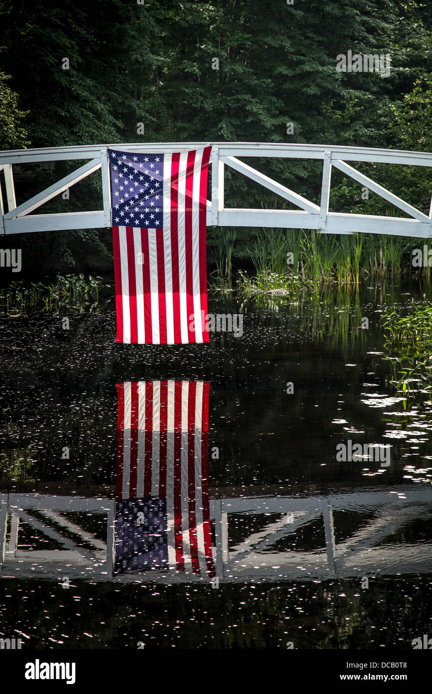 American flag hanging from wooden bridge in Somesville, Maine Stock