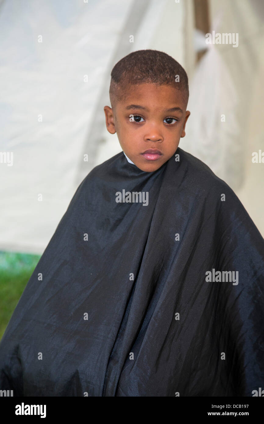 Detroit, Michigan USA. A boy gets a haircut at a Back to School Festival  sponsored by Greater Grace Temple, a 6,000-member Pentecostal church. The  annual festival features games, food, health screenings, haircuts,