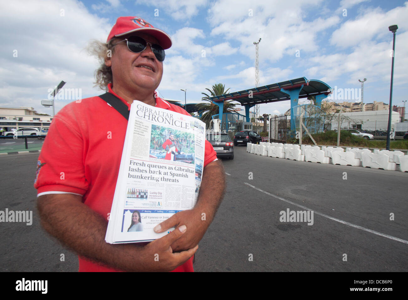 Gibraltar. 14th August 2013.  A newspaper vendor sells Gibraltar Chronicle at the border.  Tensions rise between the British and Spanish governments after Spain imposed additional border checks as Britain sends warships to Gibraltar Credit:  amer ghazzal/Alamy Live News Stock Photo