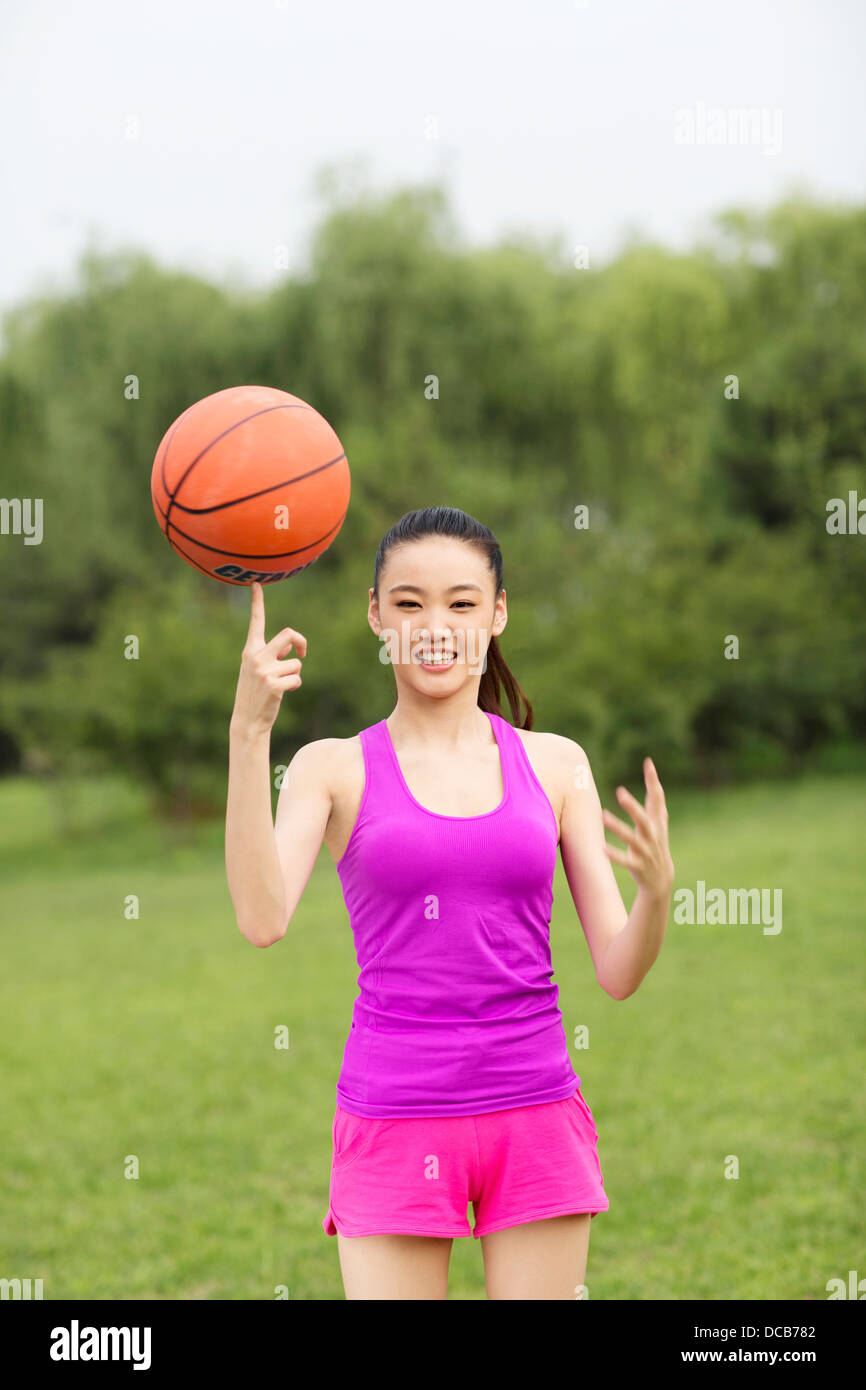 Young woman holding a basketball Stock Photo - Alamy