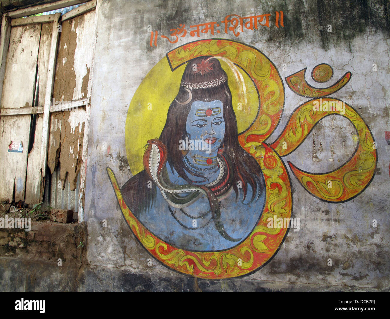 painting of the god Shiva on side of house in Varanasi backstreet india Stock Photo