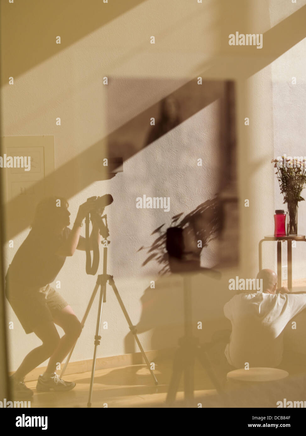 Student photographers are reflected in exhibition photographs in a gallery in Missoula, Montana