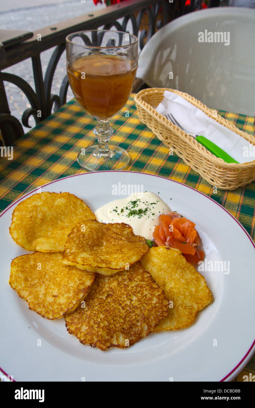 Local cuisine savory pancakes with salmon and kvass beverage in restaurant Vilnius Lithuania Europe Stock Photo