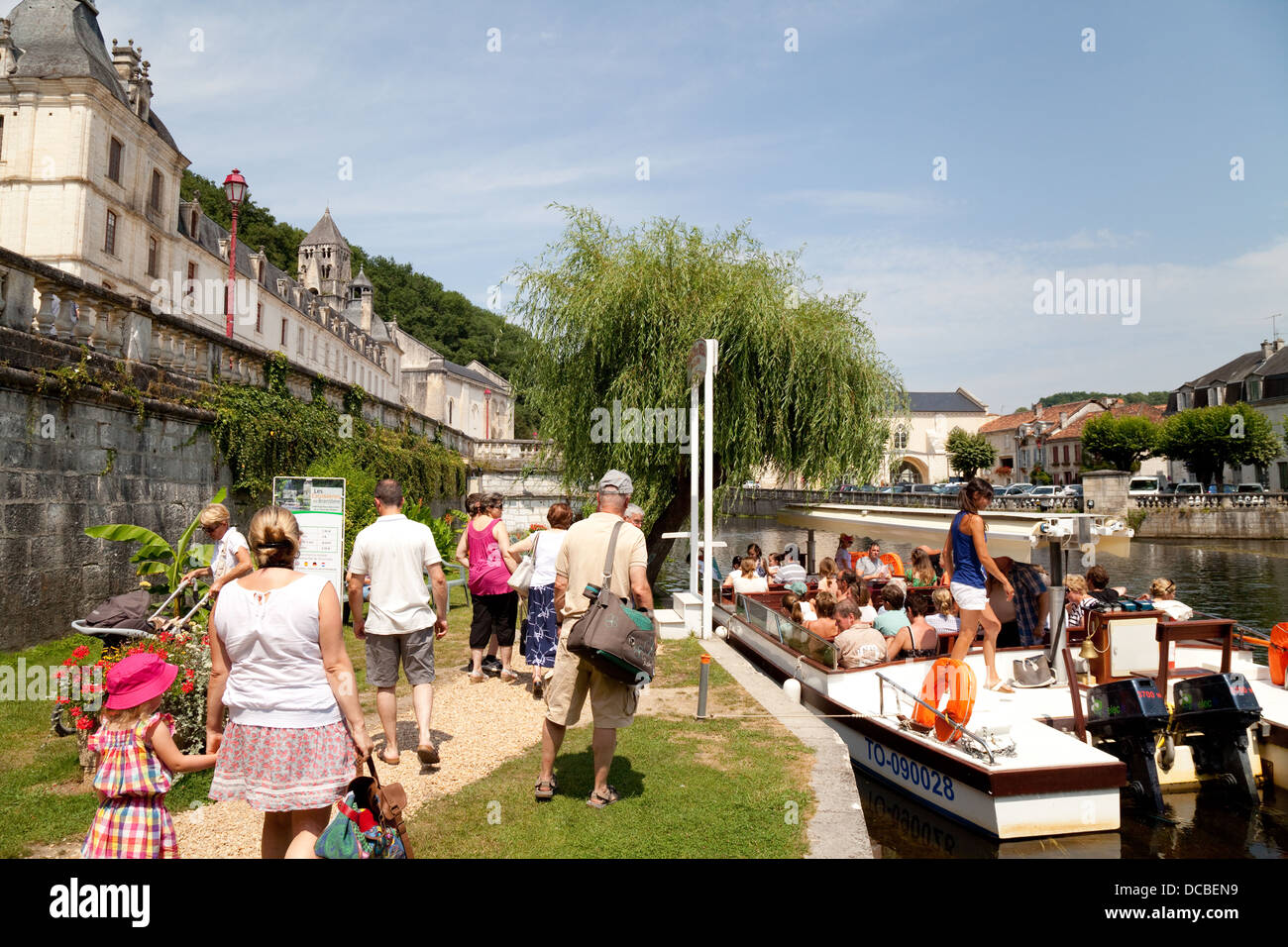 Tourists embarking on a guided boat trip on the river Dronne by the Benedictine Abbey, at Brantome, the Dordogne, France Europe Stock Photo