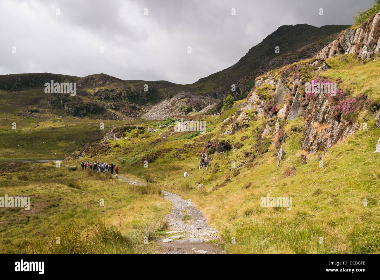Path to Carnedd Moel Siabod with walkers hikers approaching slate quarry in mountains of Snowdonia National Park, North Wales, UK Stock Photo