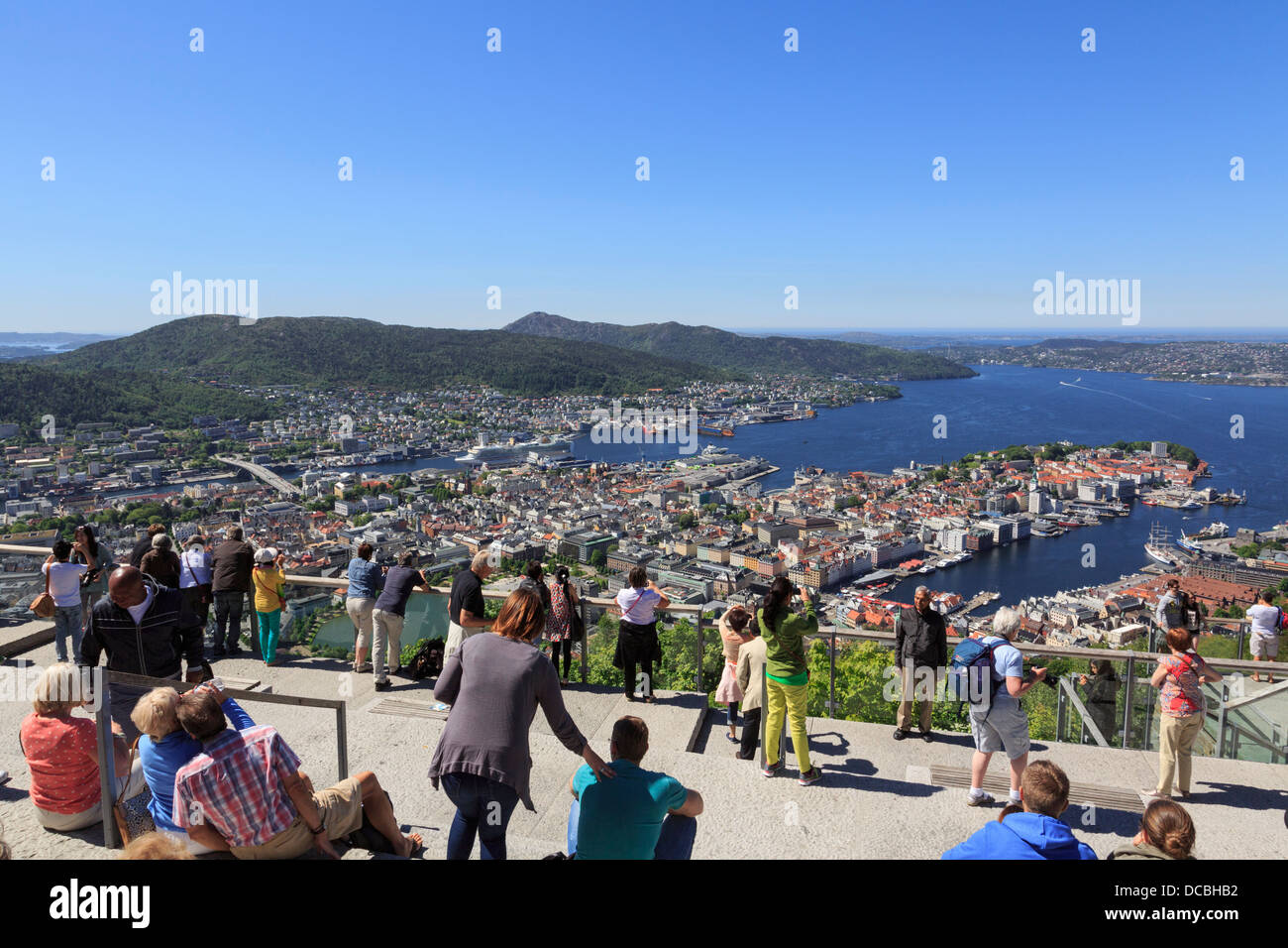 Tourists with view of city and coastline at busy viewpoint on Mount Floyen, Bergen, Hordaland, Norway, Scandinavia Stock Photo