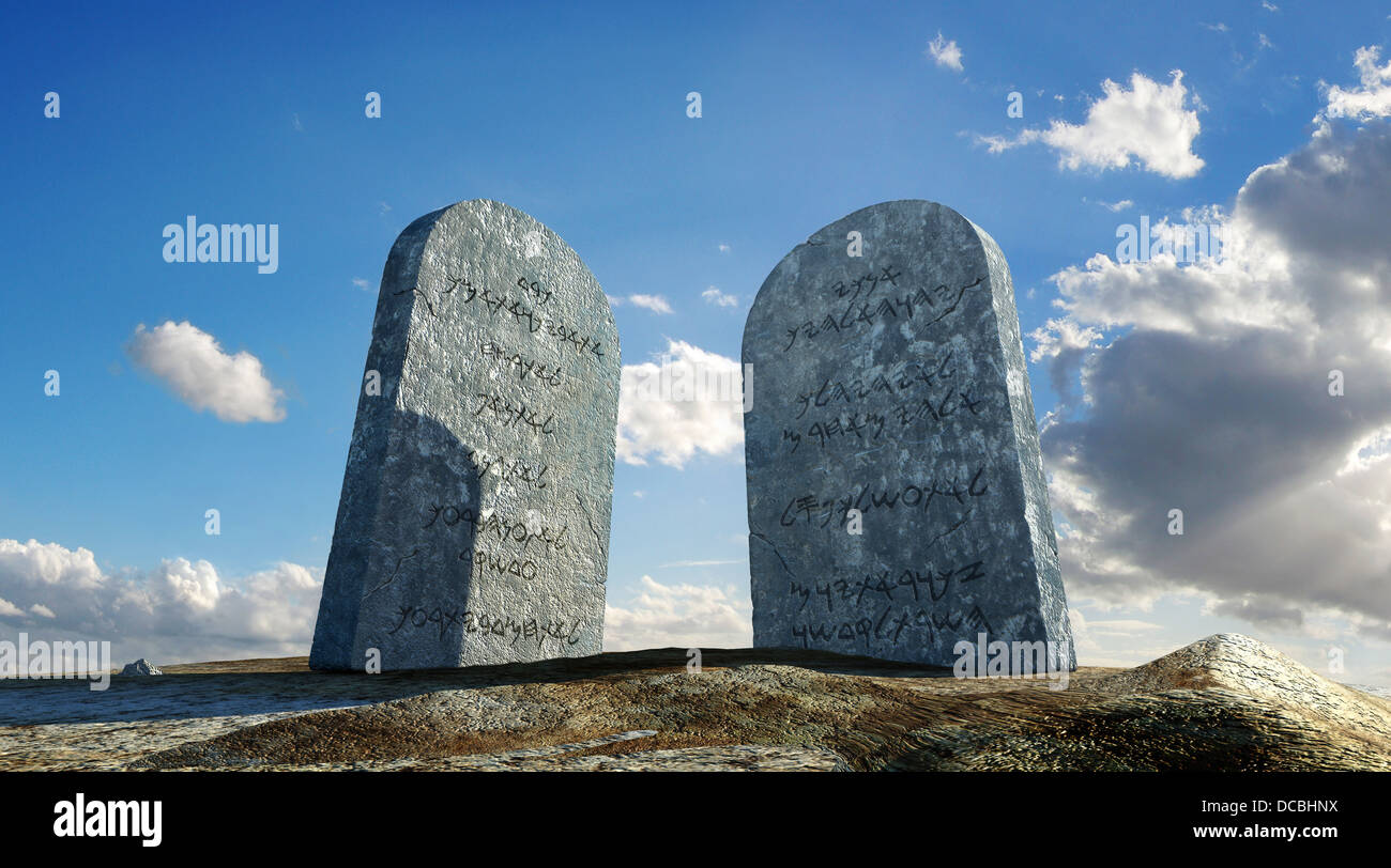 Ten commandments stones, viewed from ground level in dramatic perspective, with sky and clouds in background. Stock Photo