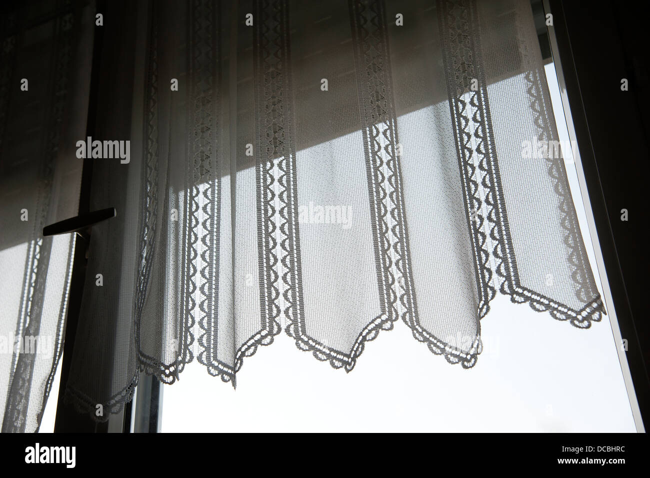 Lace curtain hanging at a window in France Stock Photo Alamy