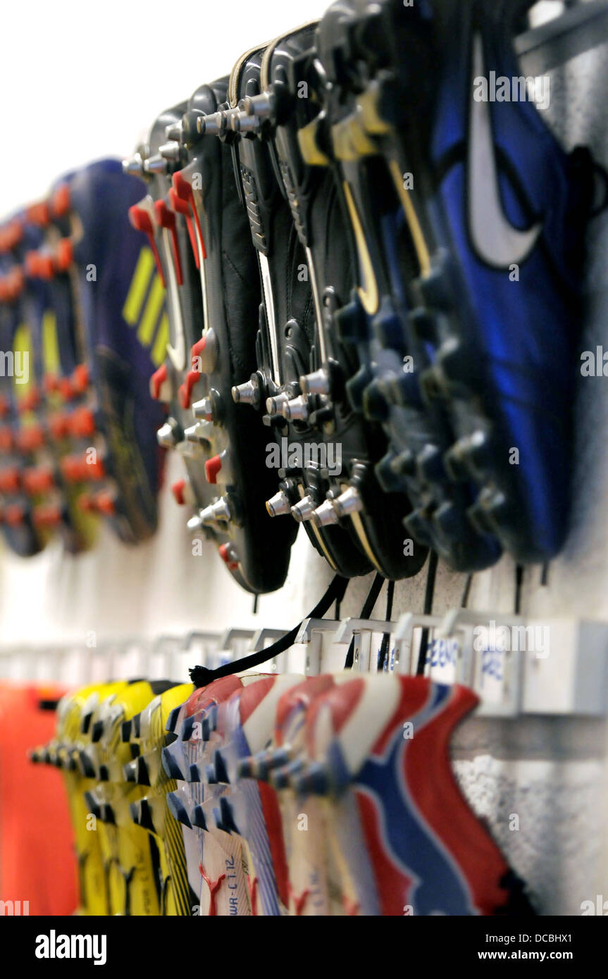 Football boots hanging in the dressing room Stock Photo - Alamy