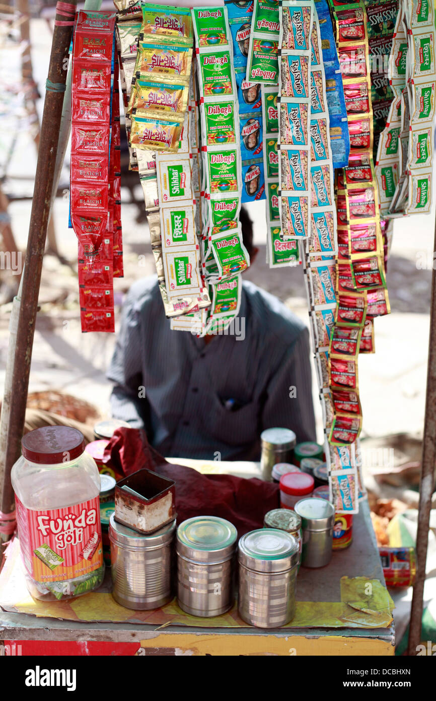 An Indian paan seller sells his wares in Delhi, India. Paan is similar to  chewing tobacco Stock Photo