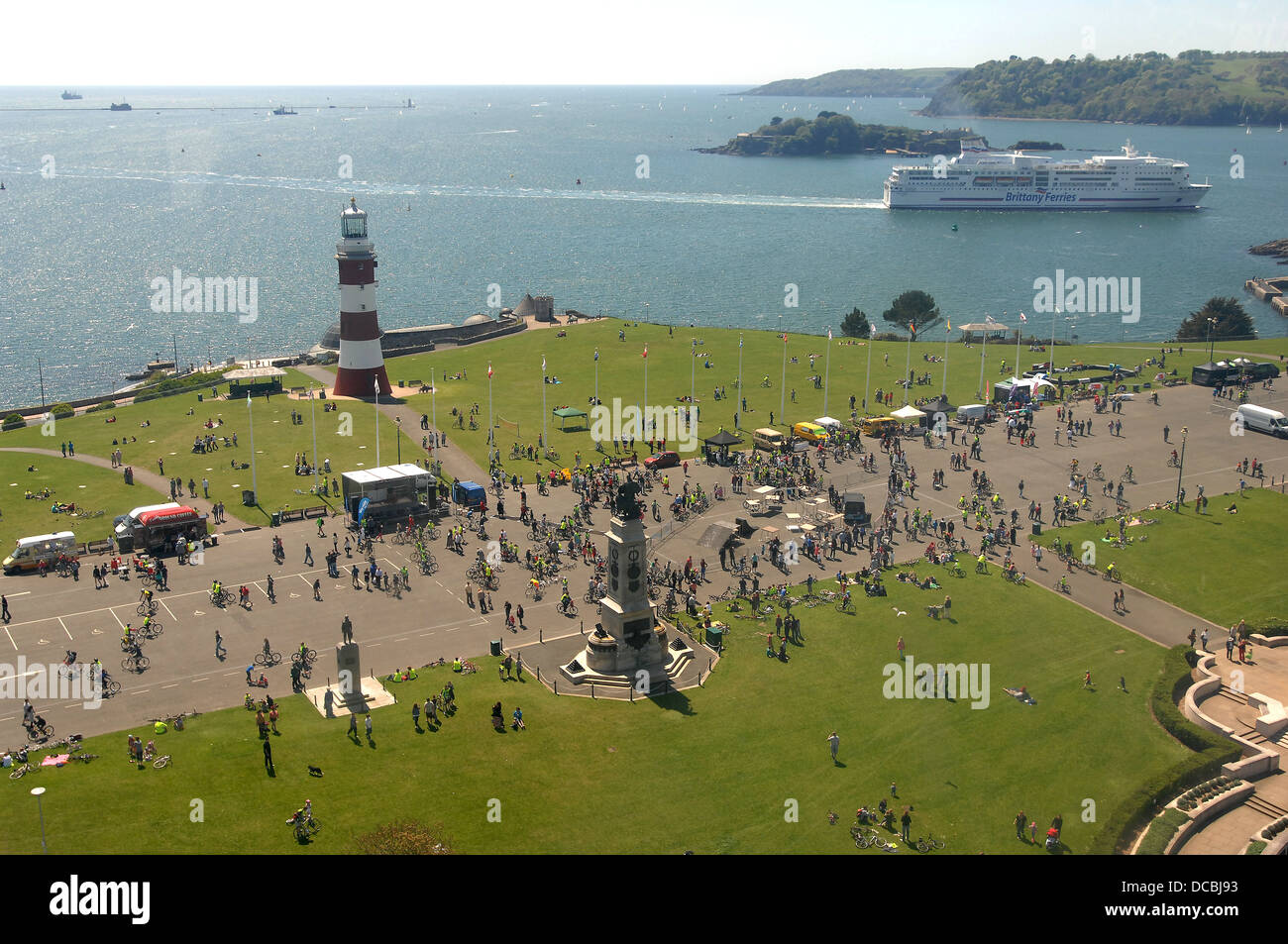A ferry comes into Plymouth as people enjoy themselves on Plymouth Hoe. Stock Photo