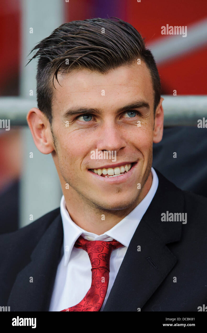Cardiff, Wales. 14th Aug, 2013. An injured Gareth Bale of Wales and Tottenham Hotspur sits in his suit on the bench before the first half of the International friendly football match between Wales and the Republic of Ireland at Cardiff City Stadium. Credit:  Action Plus Sports/Alamy Live News Stock Photo