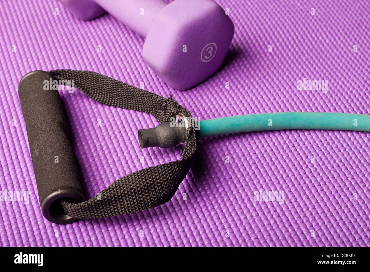 Exercise equipment on a purple yoga mat Stock Photo